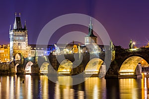 Charles Bridge and Vltava river in Prague in dusk at sunset