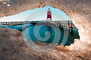 Charlevoix, MI /USA - March 3rd 2018:  Looking through melting ice at Charlevoix Michigans lighthouse