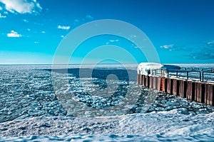 Charlevoix Michigans pier looking out over a frozen lake Michigan