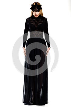 Charm. Gorgeous Woman in Long Black Dress and Cap. Haute Couture