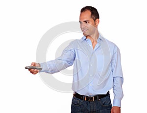 Charming adult man pointing with remote control