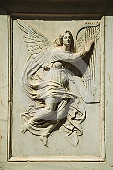 Charming angel carved in white marble at Salamanca