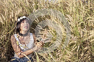 Charming Asian female relaxing outdoors on a sunny day