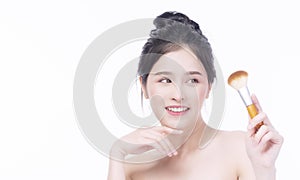 Charming Asian woman elegance nice perfect skin on white background. Beauty smile Asian young girl looking make-up brush facial