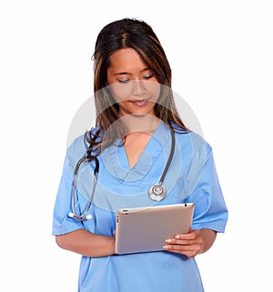 Charming asiatic nurse woman working on tablet pc