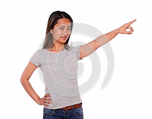 Charming asiatic young woman pointing to left up