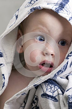 Charming baby boy in a bathrobe