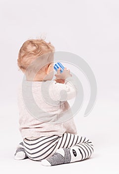 Charming baby plays with toys