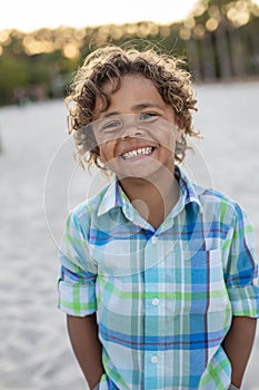 Charming Beautiful Black young boy with a playful smile and curly hair.