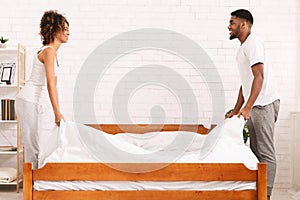 Charming beautiful couple in love making bed together