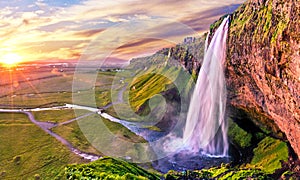 Charming beautiful waterfall Seljalandsfoss in Icelandat sunset. Exotic countries. Amazing places. Popular tourist atraction photo