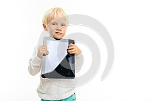 Charming blond child with a tablet with a mockup on a white background