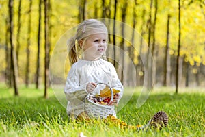 Charming blonde girl in the autumn forest.