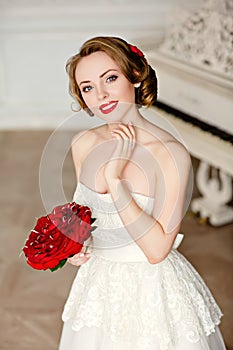 Charming blonde girl with beautiful smile in a white lace dress