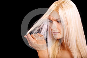 Charming blonde is not happy with fragile hair