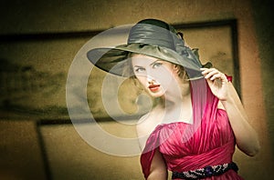 Charming blonde woman with black hat, retro image. Young beautiful fair hair female posing vintage. Mysterious lady