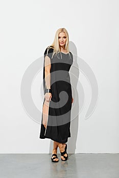 Charming blonde woman in black sleeveless dress