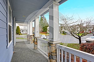 Charming blue home exterior with a nice covered porch