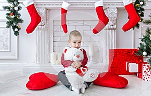 The charming boy with a big polar toy bear.