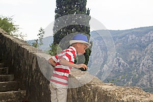 charming boy up the stairs into the mountain, and throwing pebbl