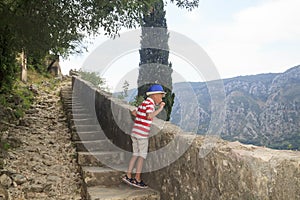 charming boy up the stairs into the mountain, and throwing pebbl