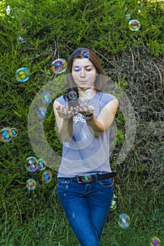 Charming brunette with bubbles outdoors