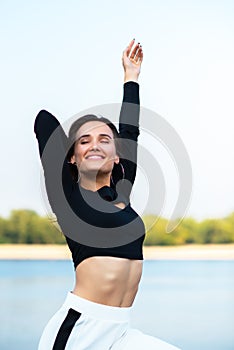 Charming brunette girl smiling and enjoying life outdoor. Young woman, summer portrait. Female model posing over nature background