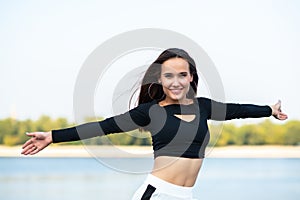 Charming brunette girl smiling and enjoying life outdoor. Young woman, summer portrait. Female model posing over nature background