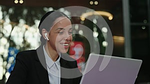 Charming Business Woman Wearing Earphones While Participating in an Online Conference. Young Professional Speaker in a