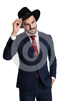 Charming businessman greeting politely with his hand in his pocket