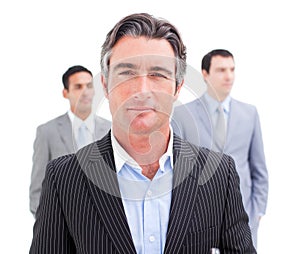 Charming businessman posing in front of his team