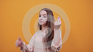 Charming caucasian young woman keeping fingers together, counting money