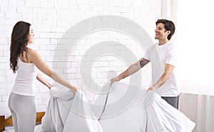 Charming couple in love making bed together