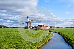 Charming dutch windmill on green grasslands