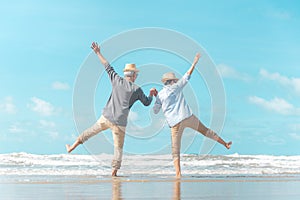 Charming elderly couple went to the beach to enjoy the sea breeze