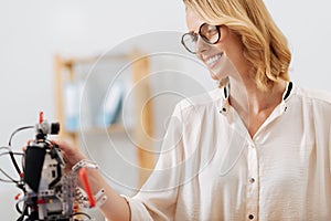 Charming engineer testing futuristic robot in the laboratory