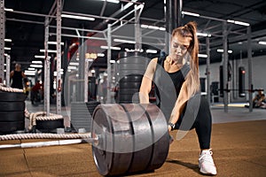 Charming female with heavy barbell