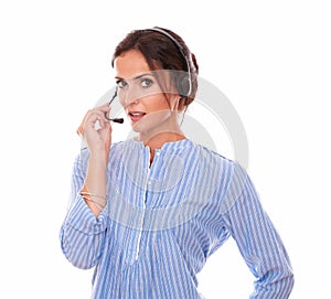 Charming female operator speaking with earphone