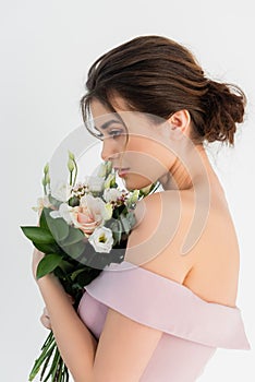 charming fiancee posing with wedding bouquet