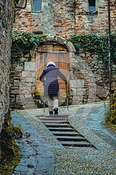 Charming French Stroll: Elderly Women Wander the Cobbled Streets of a Picturesque Village.