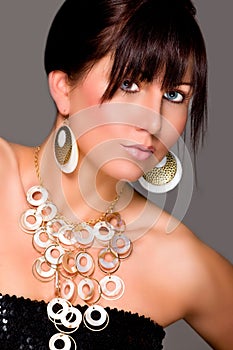 Charming girl with beautiful jewelry. Retouched