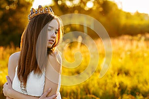 Charming girl with a crown outdoors