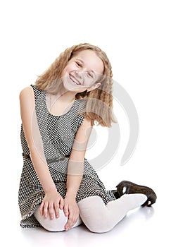 Charming girl sits on the floor photo