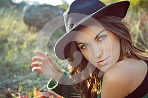 Charming girl wearing black hat with naked