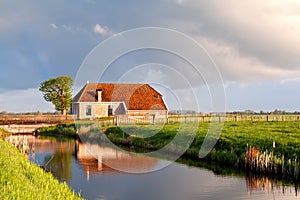 Charming house by river in sunrise sunshine