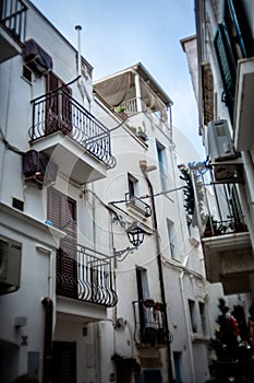 Charming Italian Balconies: White Buildings Adorned with Balconies in a Typical Polignano a Mare Street photo