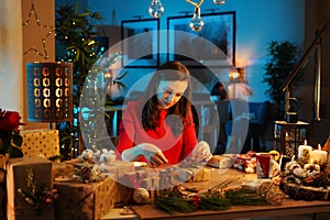 Charming lady packing the Christmas presents for family members