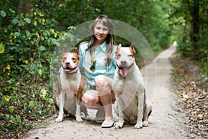 Charming lady posing with dogs outdoors.