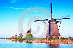 The charming landscape with windmills in Kinderdijk, Netherlands, Europe against a background of cloudy sky reflection in the