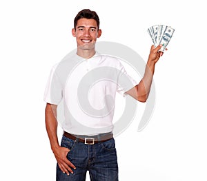 Charming latin young man is holding dollars.